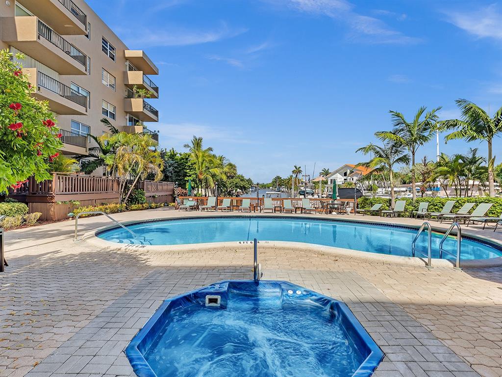 1421 South Ocean Boulevard, Unit 506 Pompano Beach, FL 33062 - Photo 29 of 36 a view of a swimming pool with a lounge chairs