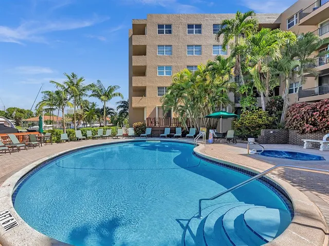 a swimming pool with outdoor seating and yard
