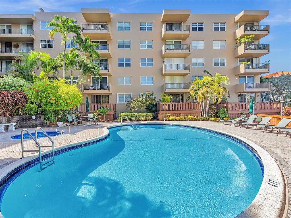 1421 South Ocean Boulevard, Unit 506 Pompano Beach, FL 33062 - Photo 31 of 36 a swimming pool with outdoor seating and yard