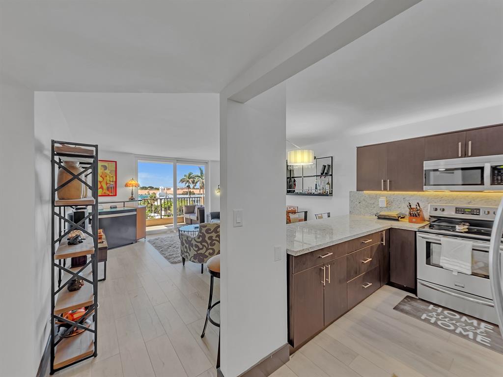 1421 South Ocean Boulevard, Unit 506 Pompano Beach, FL 33062 - Photo 4 of 36 a kitchen with a sink stove and cabinets