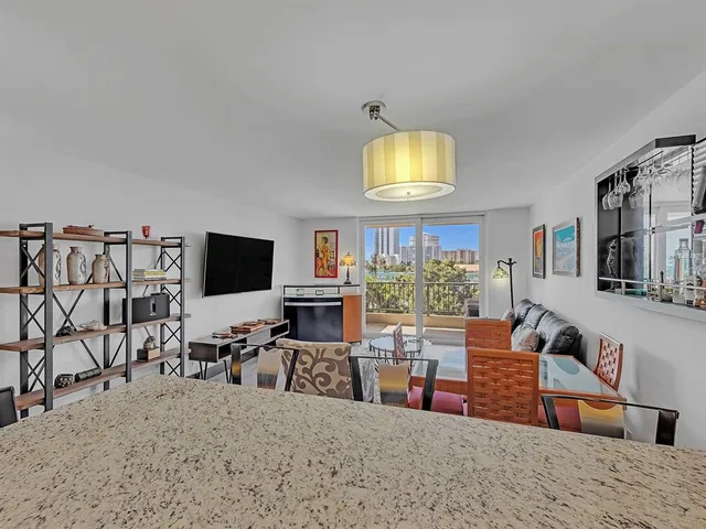 a kitchen with a refrigerator a sink and a stove top oven