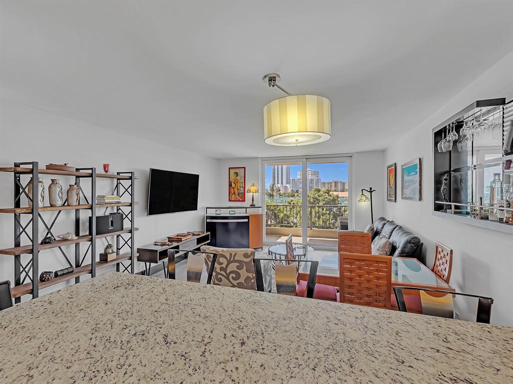 1421 South Ocean Boulevard, Unit 506 Pompano Beach, FL 33062 - Photo 9 of 36 a living room with furniture and a flat screen tv