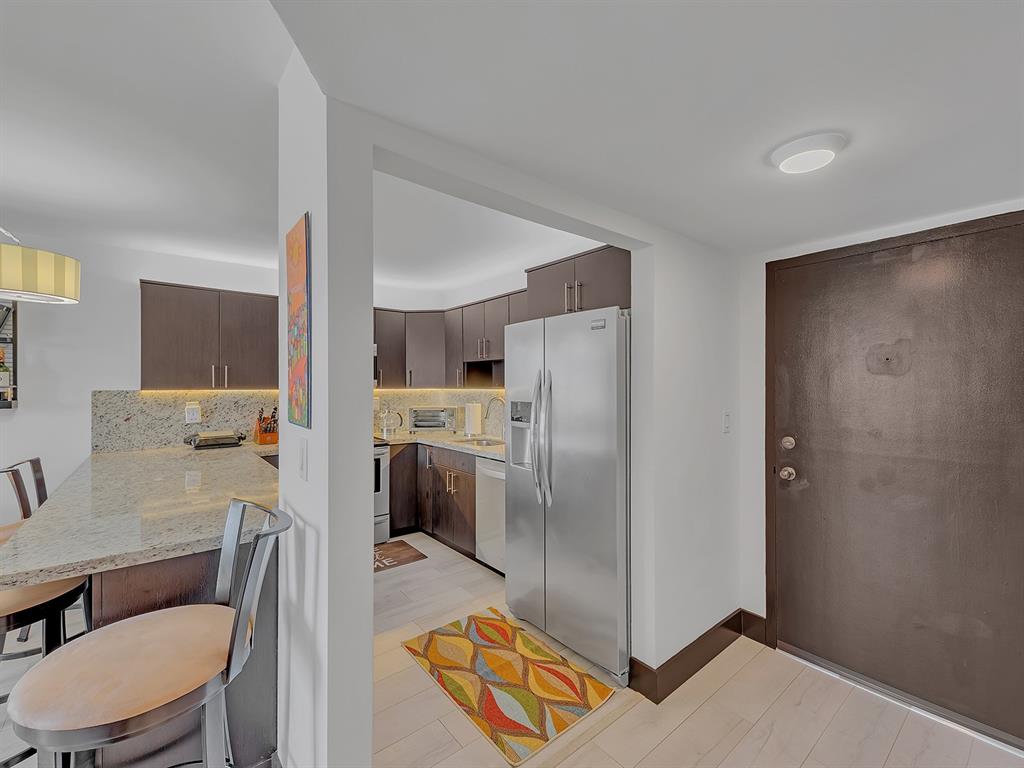 1421 South Ocean Boulevard, Unit 506 Pompano Beach, FL 33062 - Photo 10 of 36 a kitchen with a refrigerator a sink and a stove top oven