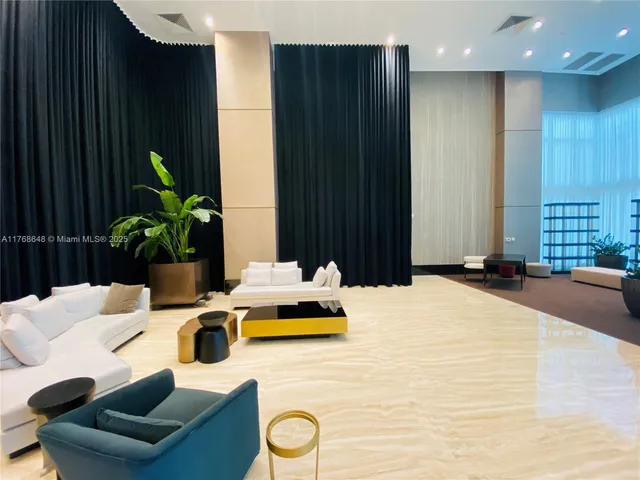 a bedroom with a bed a couch and potted plant