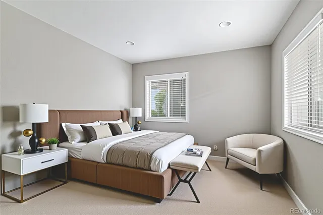 a bedroom with a bed and a chair