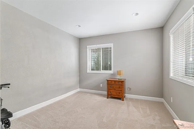 a bathroom with a sink vanity mirror and toilet