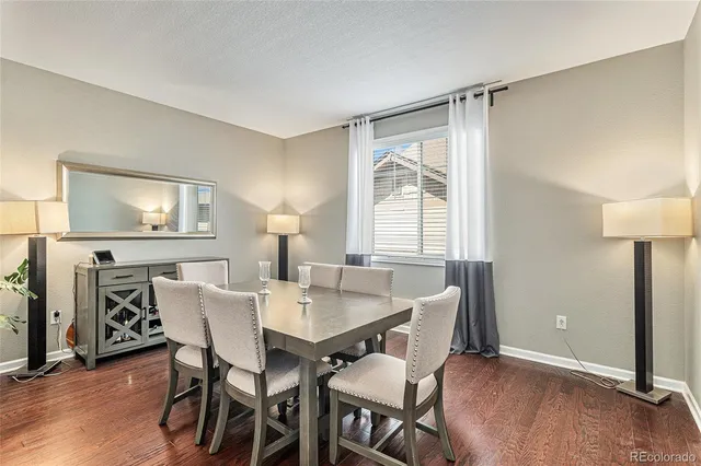 a living room with lots of furniture and kitchen view