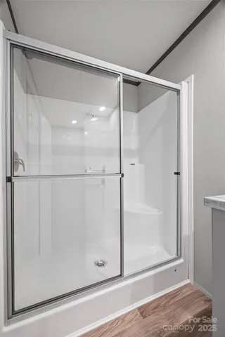 a view of a room with wooden floor