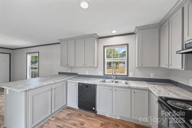 a kitchen with a sink stove and cabinets