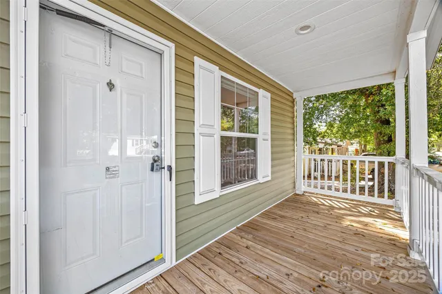 a view of a porch with wooden floor and windows