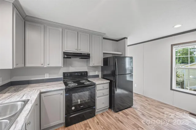 a kitchen with a sink stove and refrigerator
