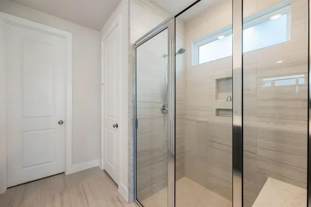 a bathroom with a glass shower door