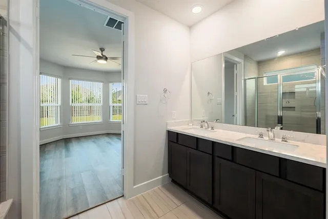a bathroom with a double vanity sink and mirror