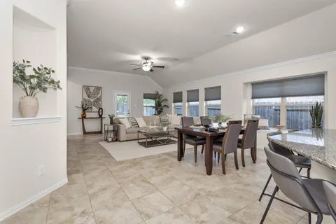 a view of a dining room with furniture and chandelier
