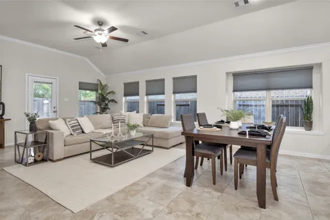 a living room with furniture a chandelier and a table