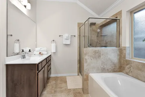 a bathroom with a tub sink and mirror