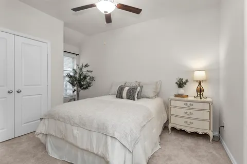 a bedroom with a bed and painting on the wall
