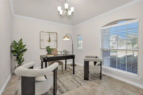 a view of a dining room with furniture and a large window