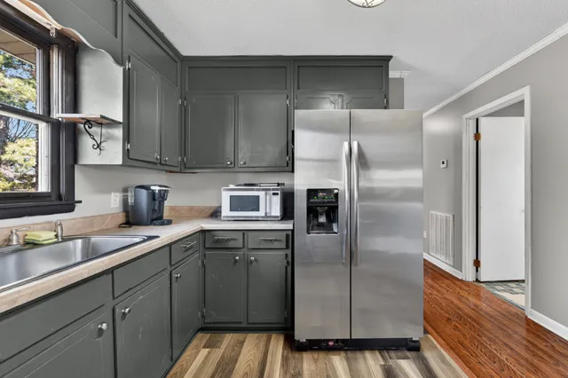 a kitchen with stainless steel appliances cabinets a sink and a counter top space