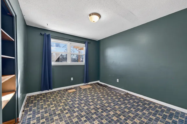 a bedroom with bed and window