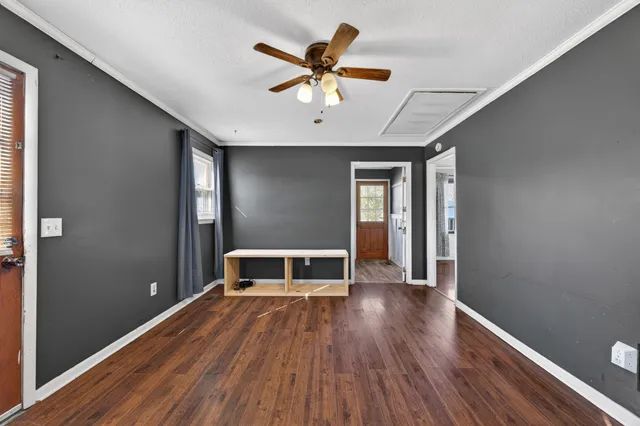 a room with a wooden floor and a window