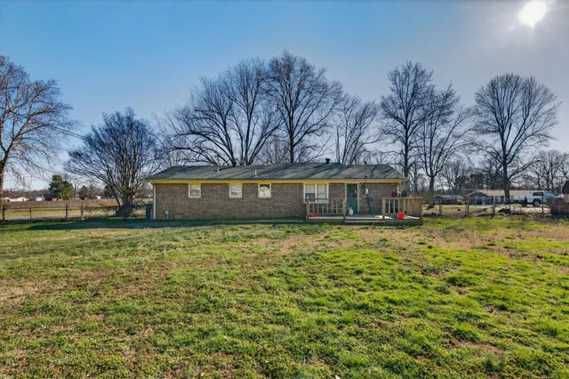 a brick house with trees in front of it