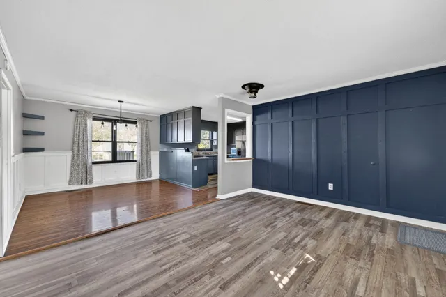 a view of a kitchen with wooden floor and a kitchen