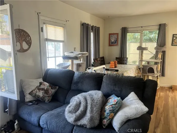 a living room with furniture fireplace and a window
