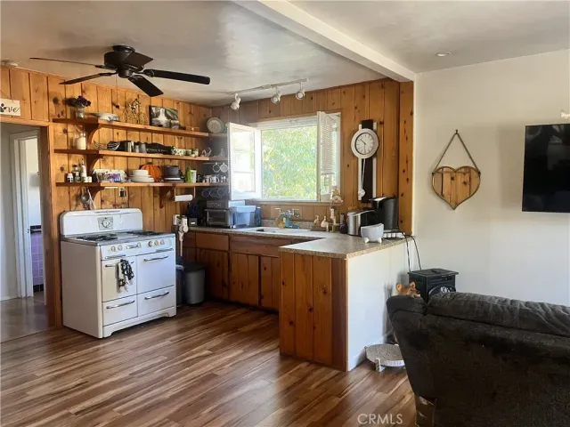 a view of kitchen with cabinets and wooden floor