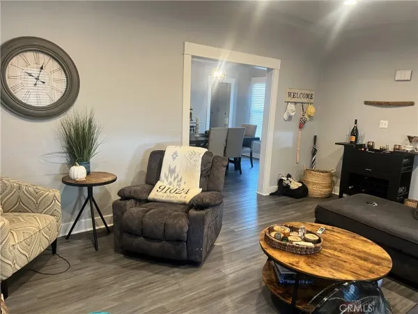 a living room with furniture a table and wooden floor