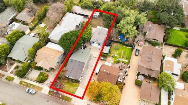 an aerial view of a house with a yard and garden