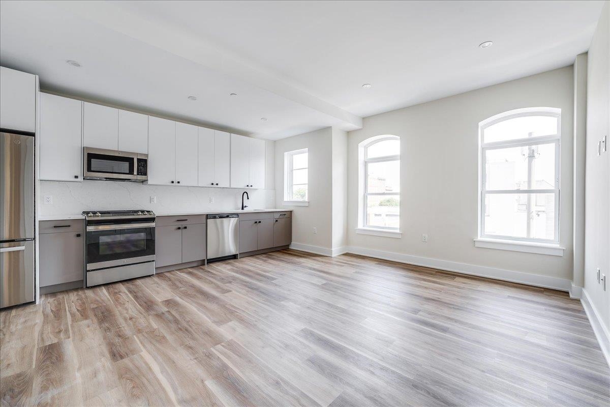 237 Washington Street, Unit 304 Hoboken, NJ 07030 - Photo 1 of 34 a kitchen with stainless steel appliances granite countertop a refrigerator sink and stove