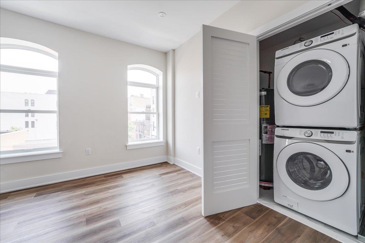 237 Washington Street, Unit 304 Hoboken, NJ 07030 - Photo 6 of 34 a view of a hallway with washer and dryer