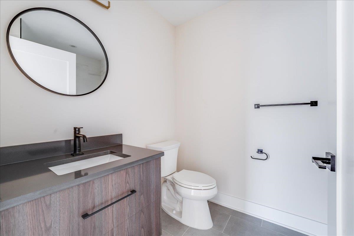 237 Washington Street, Unit 304 Hoboken, NJ 07030 - Photo 7 of 34 a bathroom with a toilet a sink and a mirror