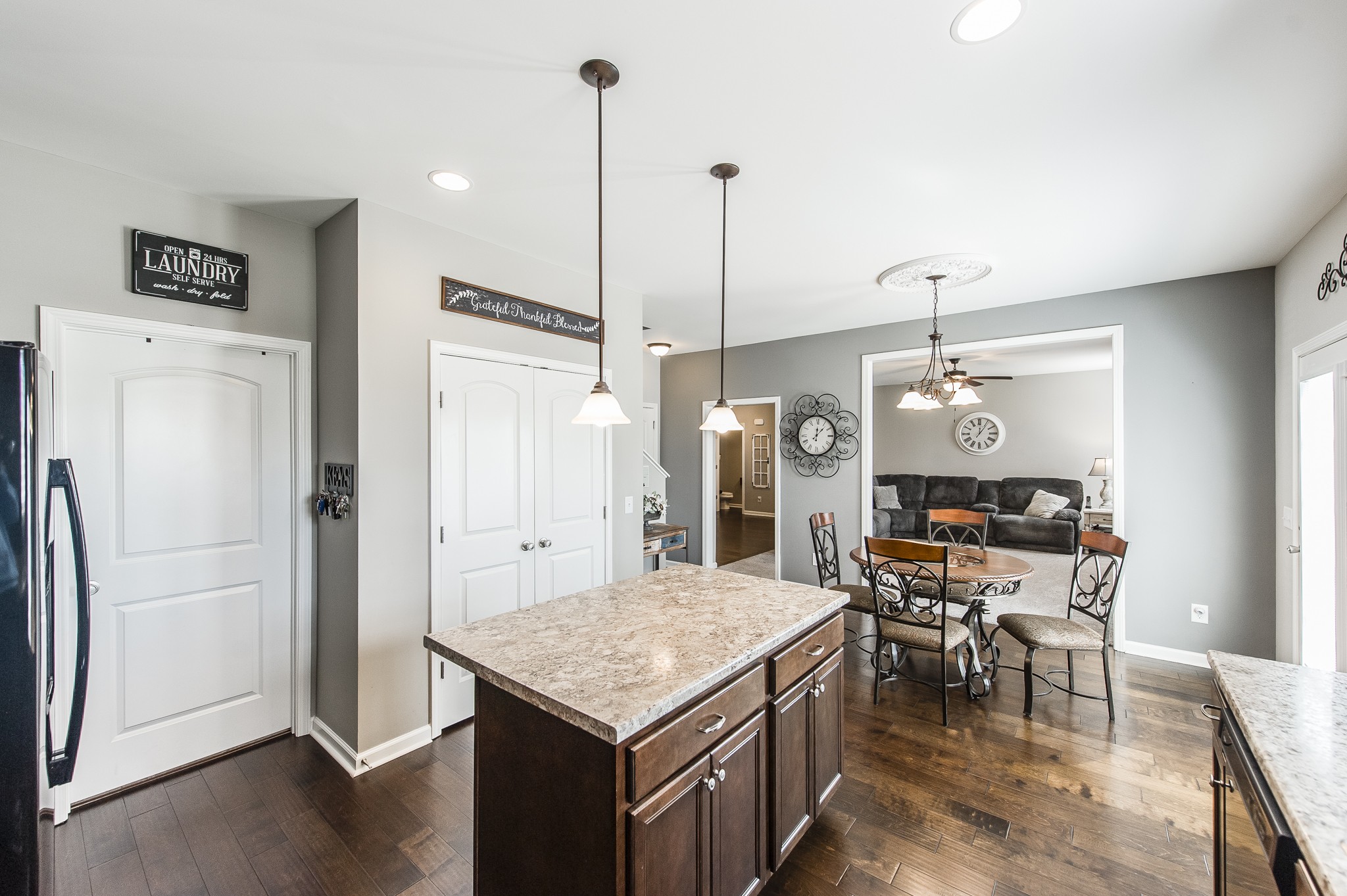 114 Monteview Drive Hendersonville, TN 37075 - Photo 19 of 42 a kitchen with kitchen island a refrigerator a stove a dining table and chairs