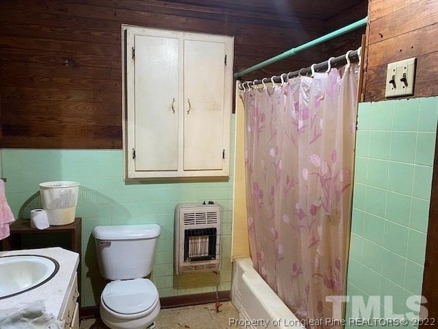 838 Jada Allen Road Dunn, NC 28334 - Photo 14 of 25 a white toilet sitting next to a bathroom sink and a shower