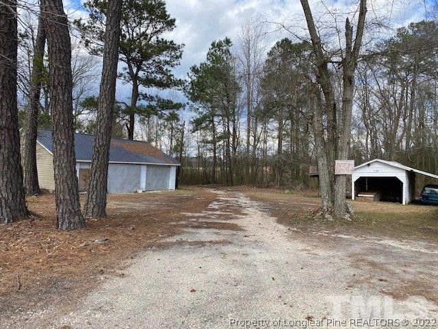 838 Jada Allen Road Dunn, NC 28334 - Photo 21 of 25 a view of a house with a yard and large tree