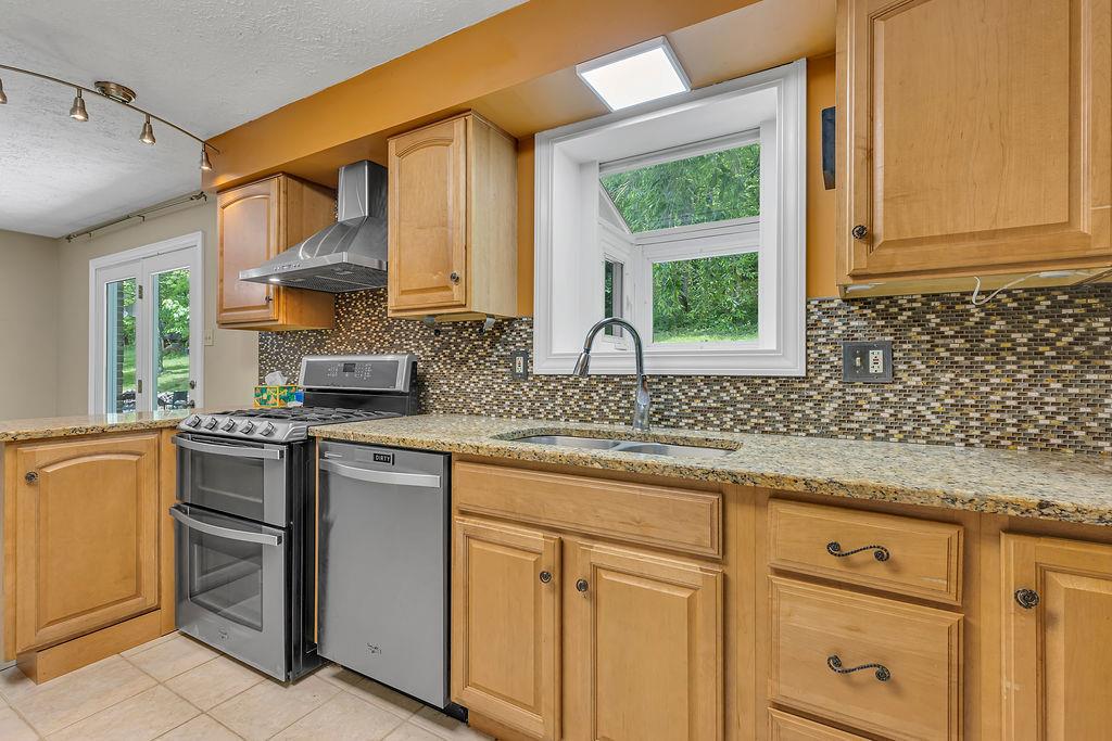 171 Dehaven Road Beaver Falls, PA 15010 - Photo 10 of 35 a kitchen with stainless steel appliances granite countertop white cabinets and a window