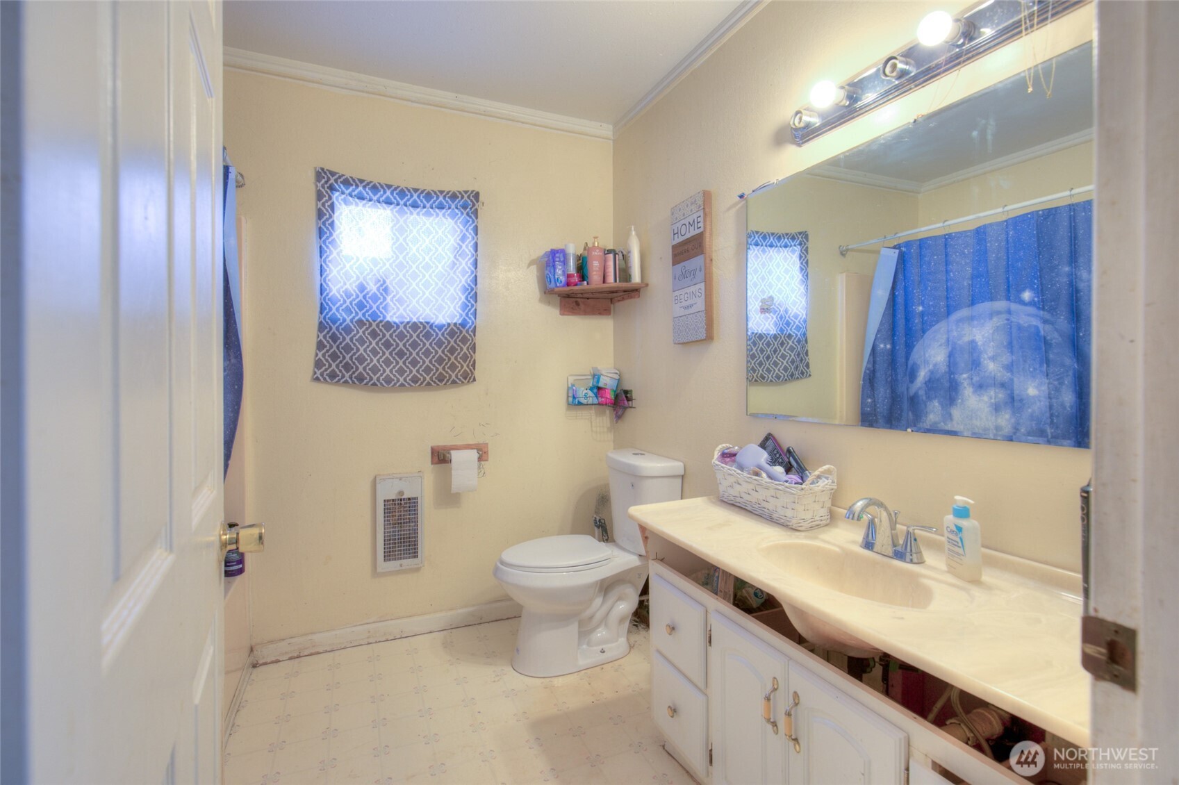 102 Elma Street Copalis Beach, WA 98535 - Photo 12 of 23 a bathroom with a granite countertop sink mirror vanity and toilet