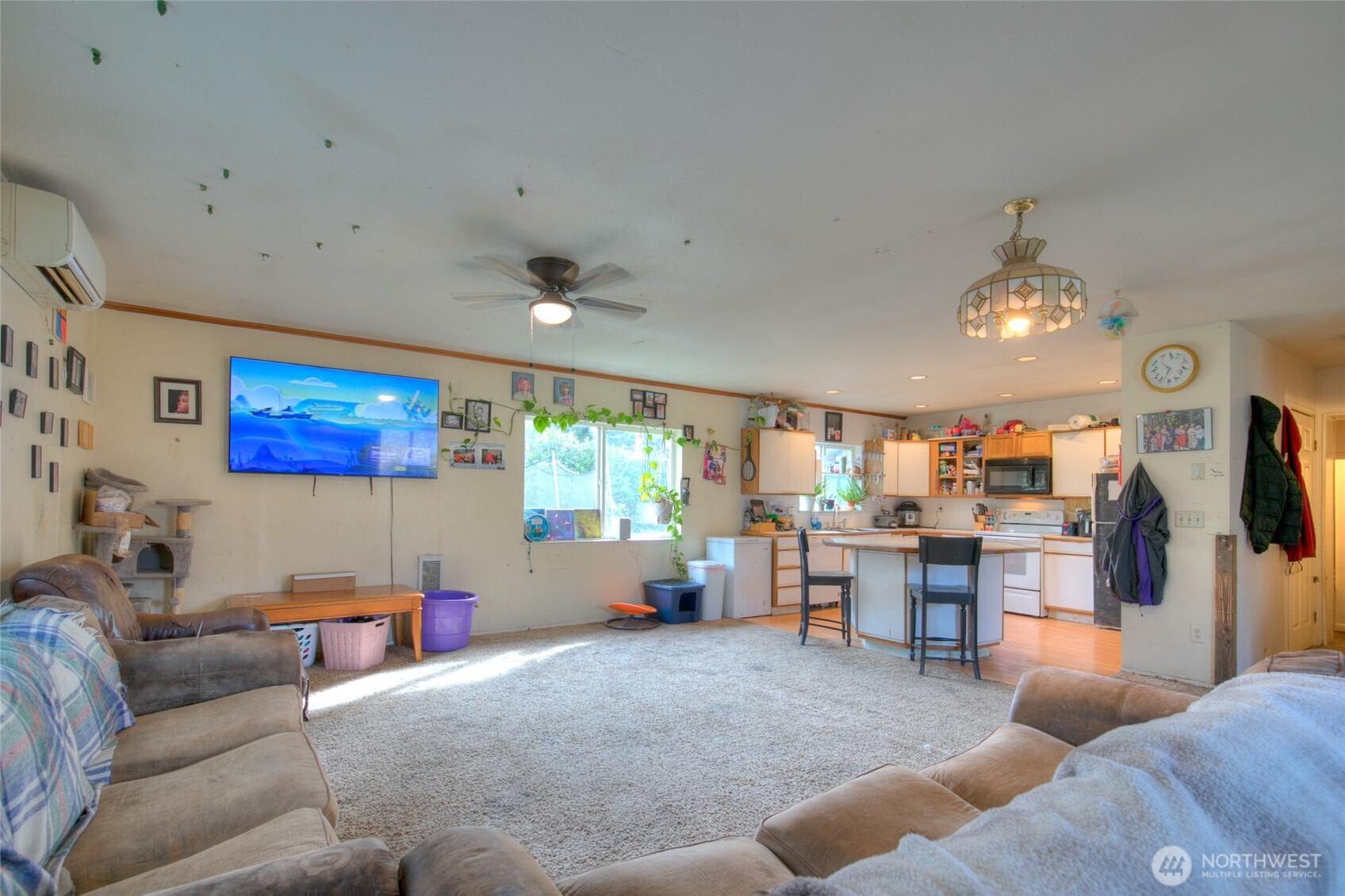 102 Elma Street Copalis Beach, WA 98535 - Photo 5 of 23 a living room with furniture and a flat screen tv
