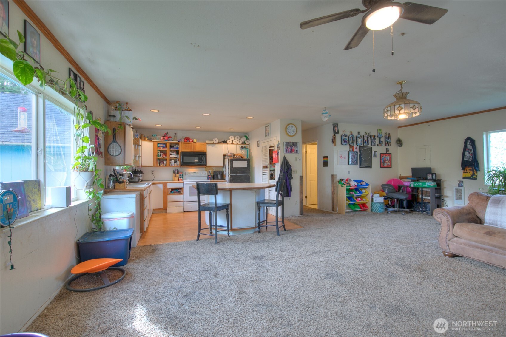 102 Elma Street Copalis Beach, WA 98535 - Photo 6 of 23 a living room with furniture and a chandelier