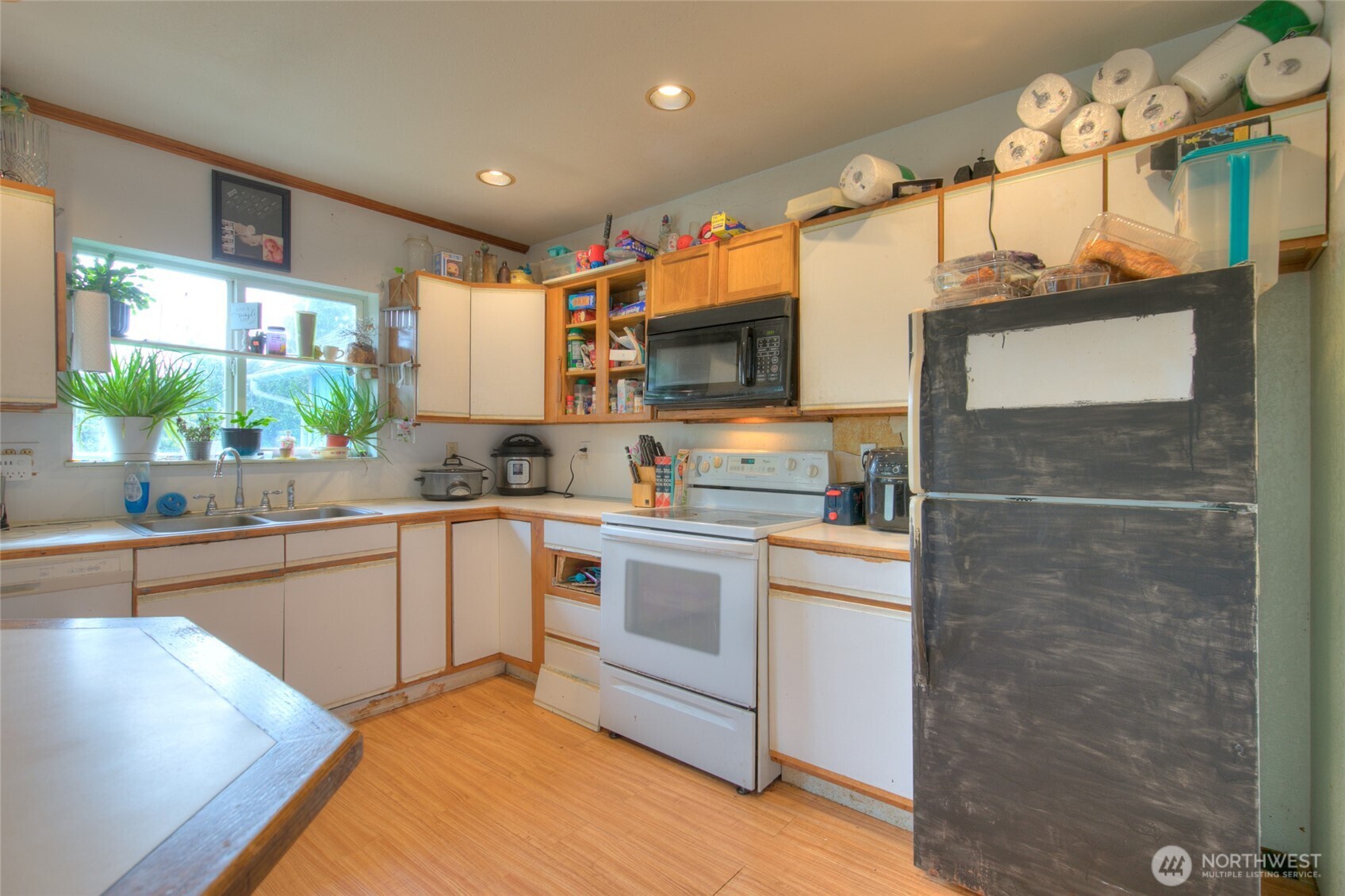 102 Elma Street Copalis Beach, WA 98535 - Photo 7 of 23 a kitchen with kitchen island granite countertop a sink cabinets stainless steel appliances and a counter top space