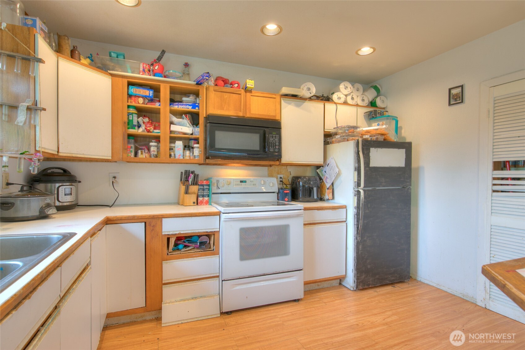 102 Elma Street Copalis Beach, WA 98535 - Photo 9 of 23 a kitchen with stainless steel appliances a stove a sink and a refrigerator