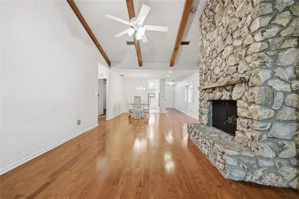 wooden floor in an empty room with a fireplace