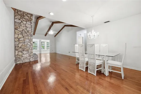 a view of a livingroom with wooden floor and white walls