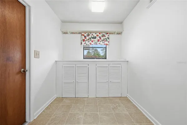 a room with a sink cabinets and a window