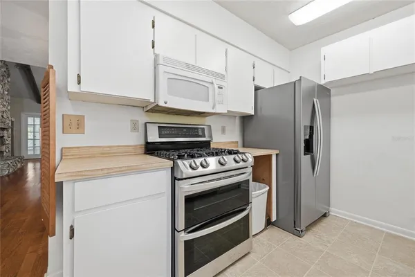 a stove top oven sitting inside of a kitchen