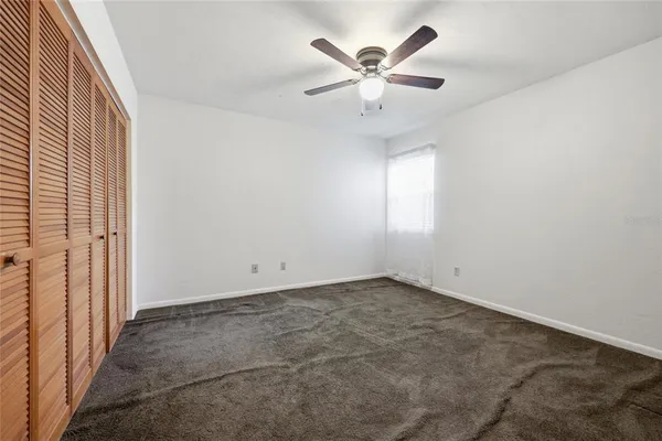 an empty room with ceiling fan