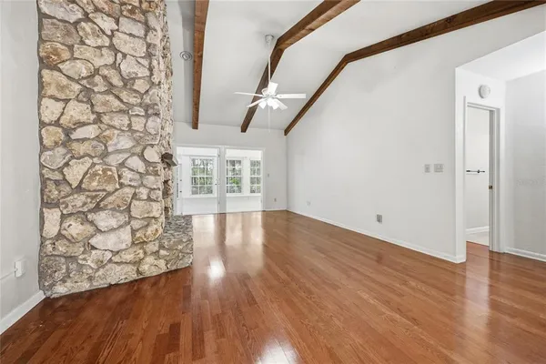 wooden floor in an empty room with a window