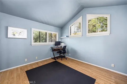 a view of a workspace with furniture and a window
